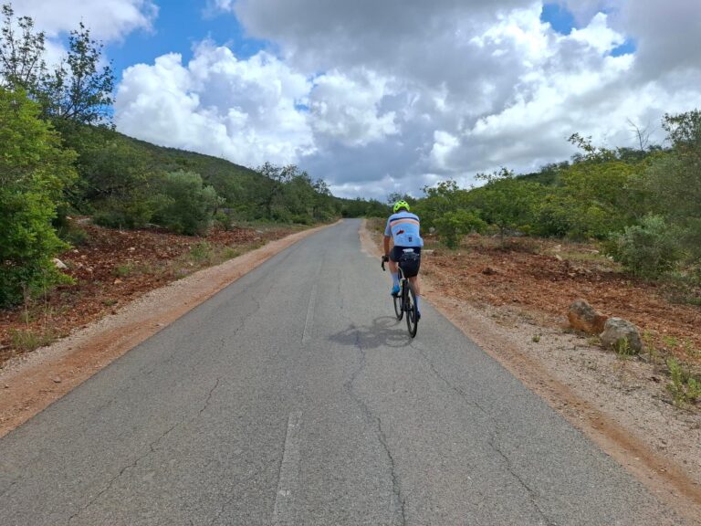 Cyclists riding one of the best cycling routes in the Algarve on a quiet Portuguese road